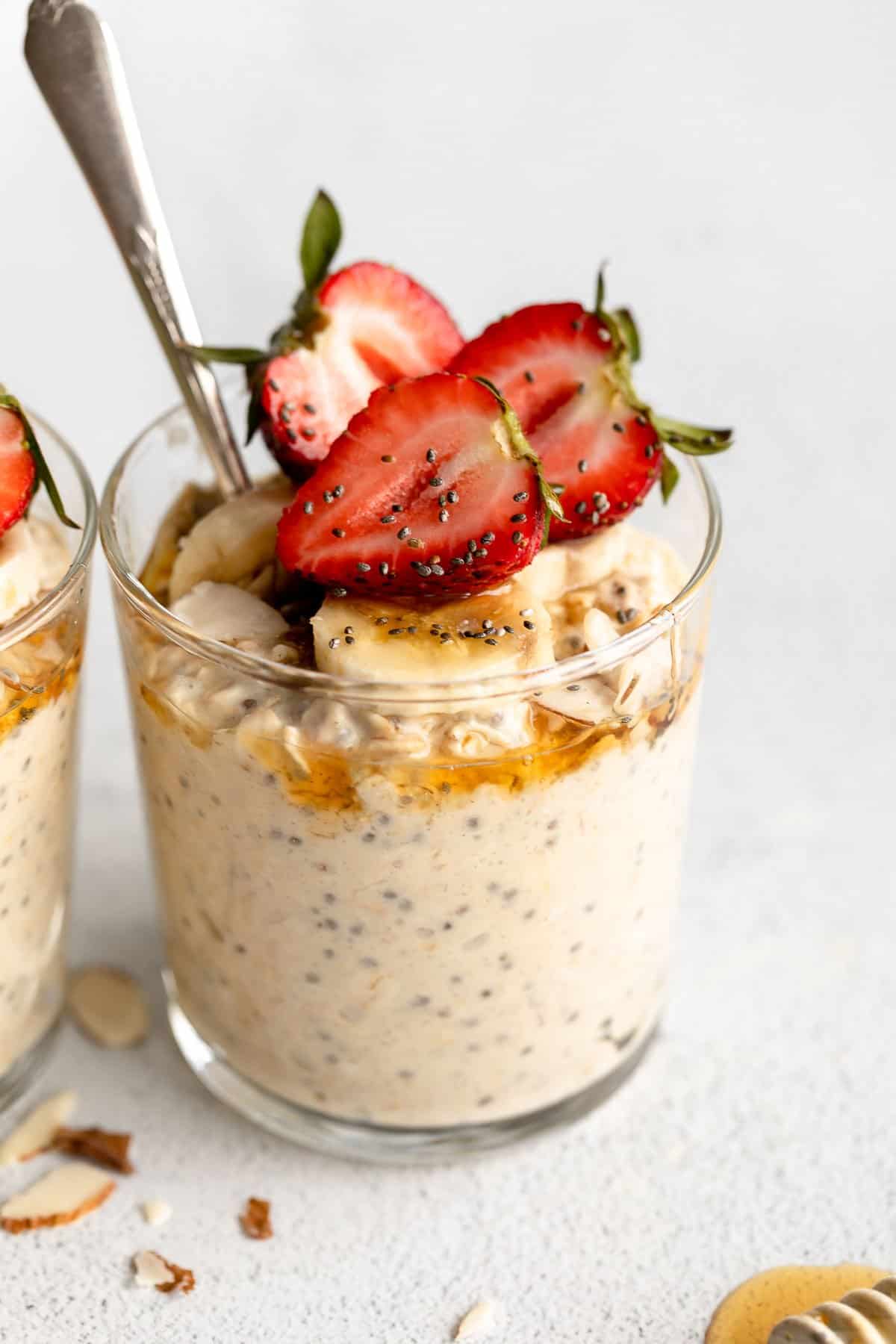 protein overnight oats in a glass jar with banana and strawberries